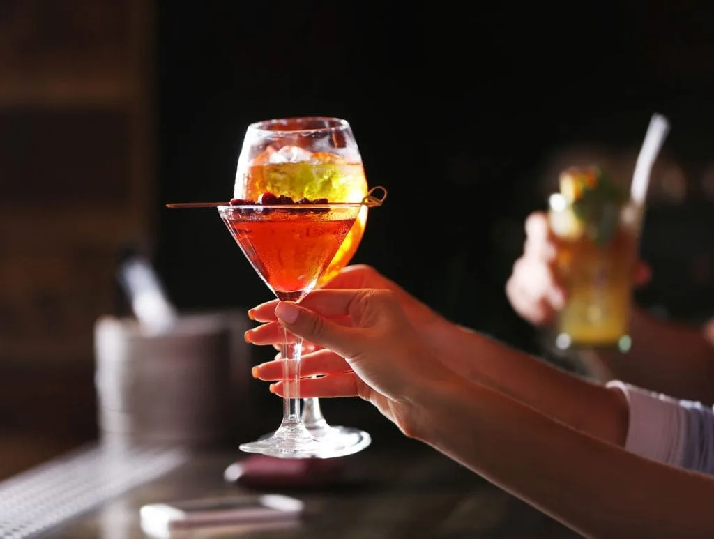 toasting with cocktails in bar  1024x773
