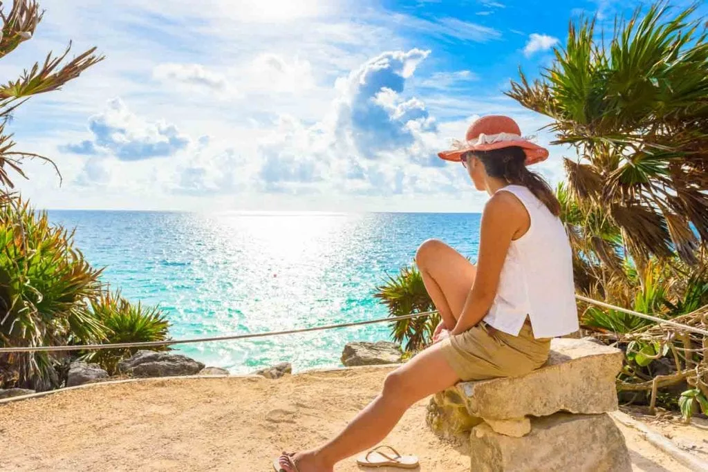 woman overlooking the water in Tulum 1024x683