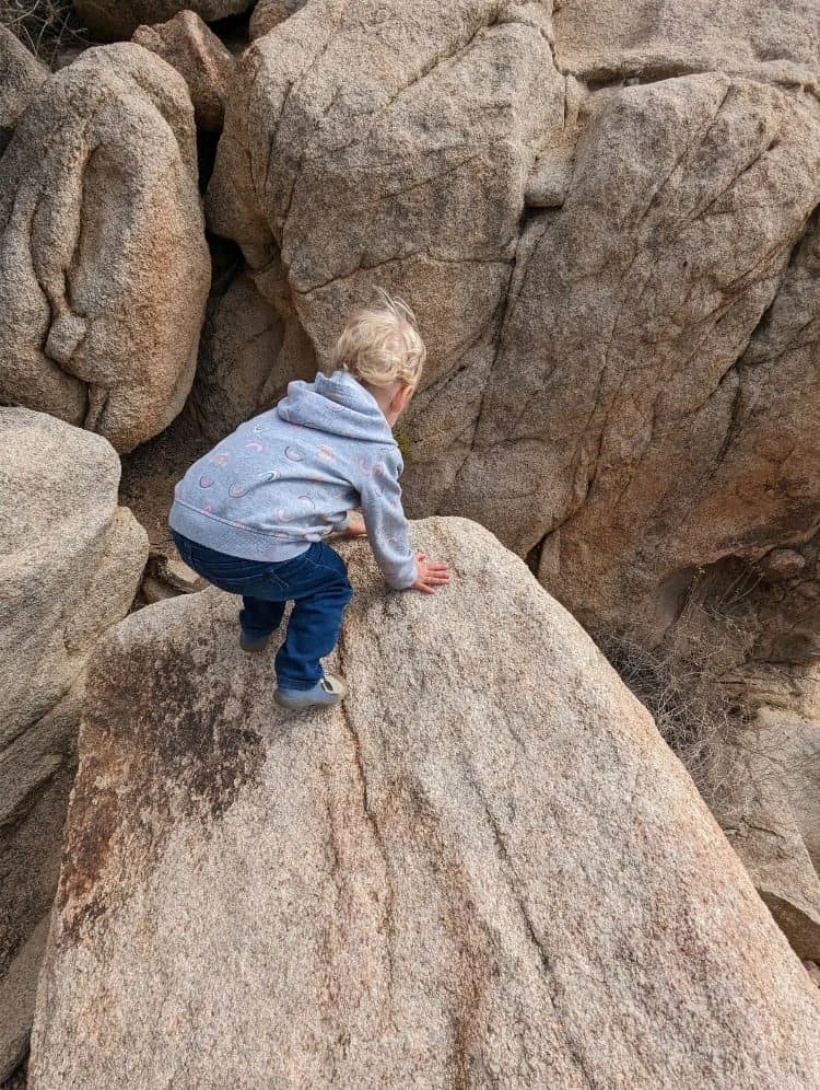 child climbing rock