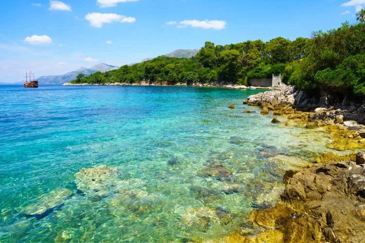 A boat on a rocky shore of Kolocep Island