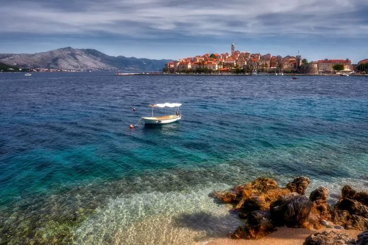 Croatia island of Korcula view of the city of Korcula and a white boat on the sea